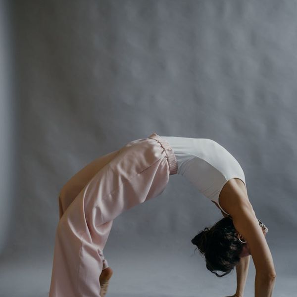 A calm and focused person demonstrating a gentle stretching pose.